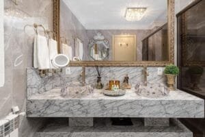 Luxury hotel-inspired bathroom design with marble countertop and large mirror