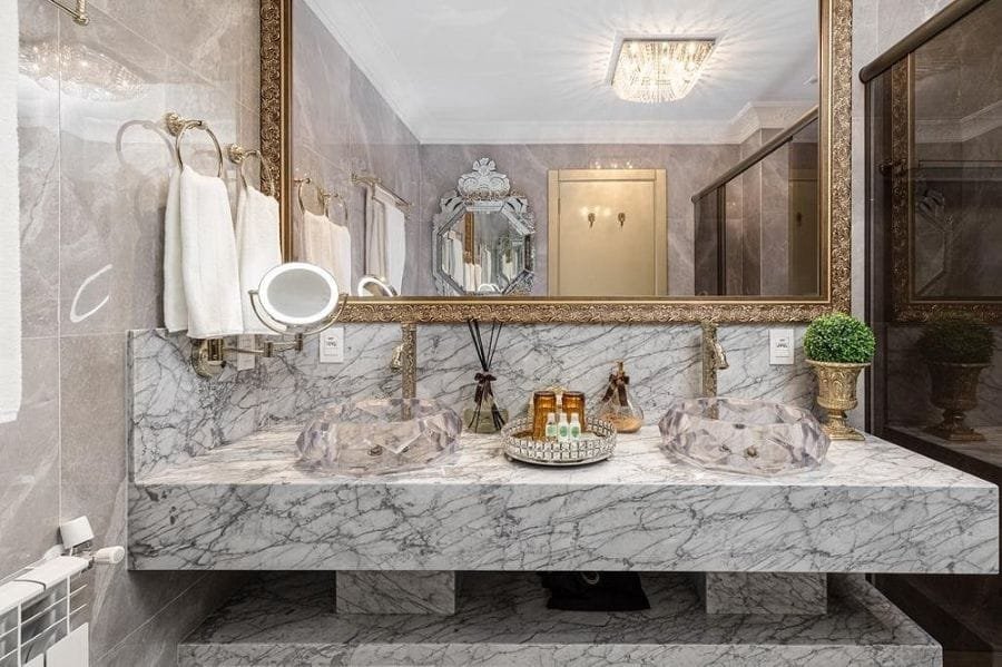 Luxury hotel-inspired bathroom design with marble countertop and large mirror